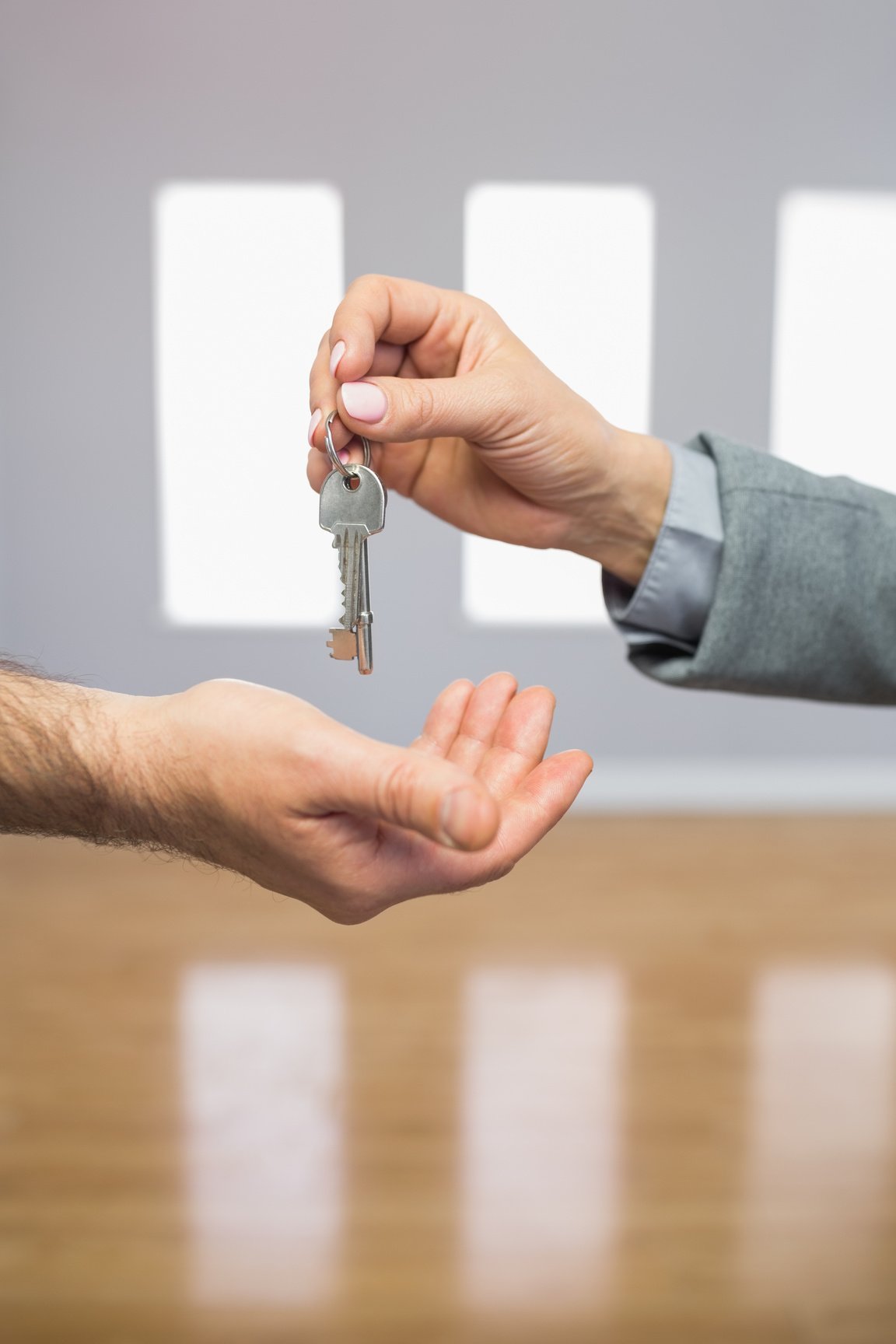 Realtor giving house key to buyer